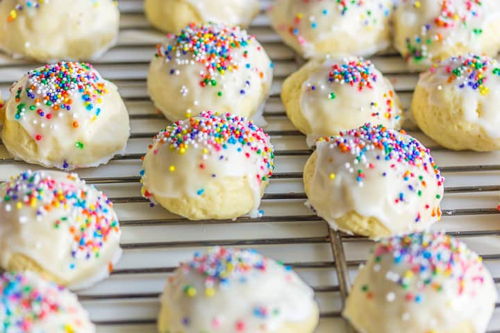 Finished cookies on a baking rack, after frosting being applied